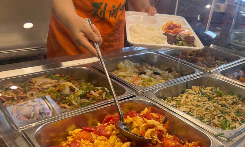 A staff member serves meals for senior citizens inside a community canteen in Luyang District of Hefei, capital of east China's Anhui Province, Sept. 29, 2022. Photo: Xinhua