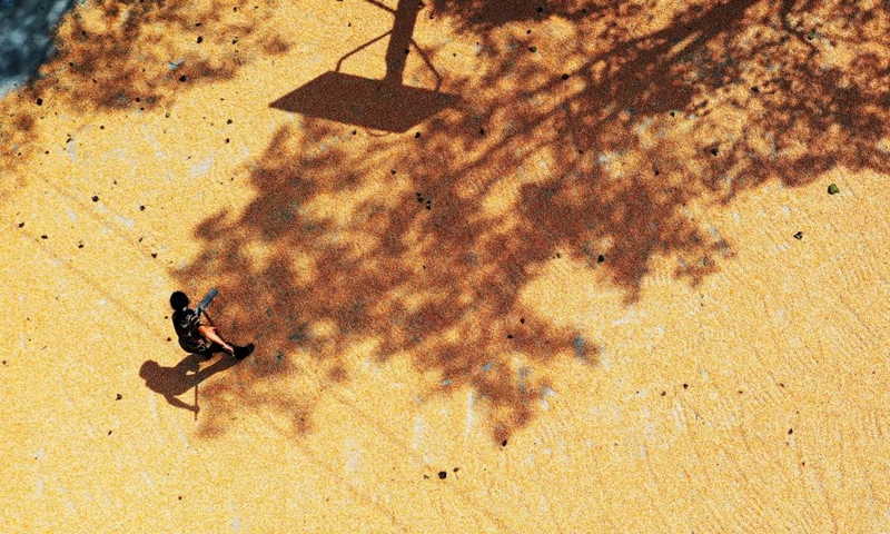 Aerial photo taken on Oct. 4, 2022 shows a farmer drying corn in Sanjiang Village of Niuchang Township in Fuquan City of southwest China's Guizhou Province.(Photo: Xinhua)