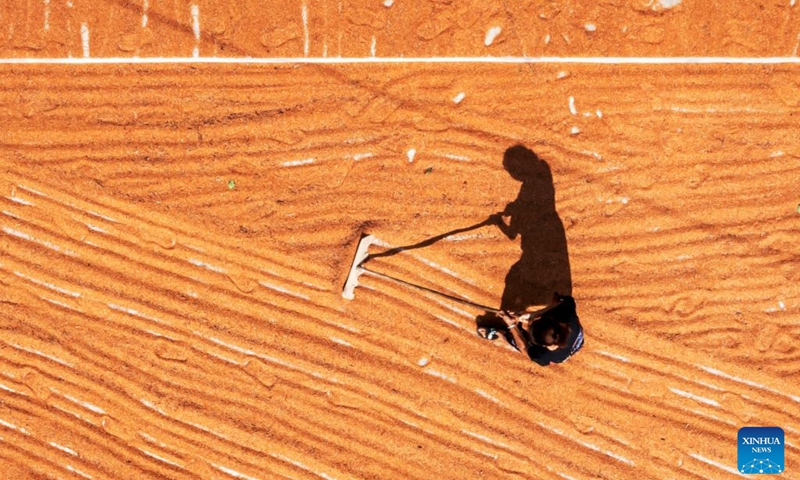 Aerial photo taken on Oct. 5, 2022 shows a villager dries sorghum in Gantang Township of Qianxi City, southwest China's Guizhou Province.(Photo: Xinhua)