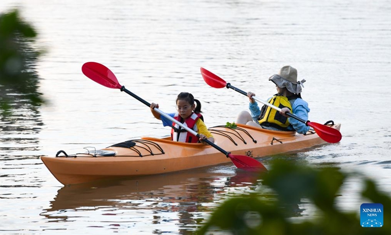 Tourists paddle a kayak around Liuke Village of Boao Town in Qionghai, south China's Hainan Province, Oct. 2, 2022.Photo:Xinhua