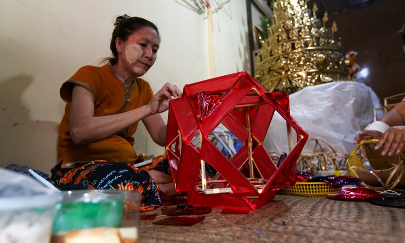 A woman makes a traditional lantern for Thadingyut lighting festival in Yangon, Myanmar, Oct. 7, 2022.(Photo: Xinhua)