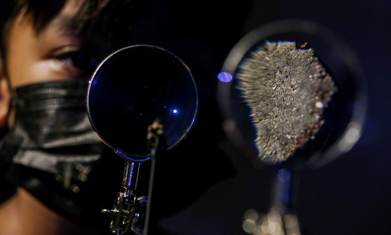 A boy takes a close look at the Pantar and Bondoc meteorites as they are unveiled at the Philippine National Museum in Manila, the Philippines, Oct. 11, 2022.(Photo: Xinhua)