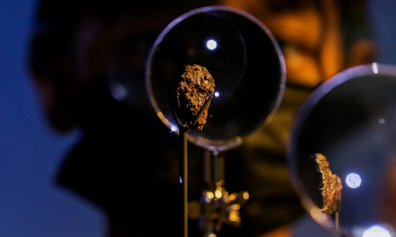 A boy takes a close look at the Pantar and Bondoc meteorites as they are unveiled at the Philippine National Museum in Manila, the Philippines, Oct. 11, 2022.(Photo: Xinhua)