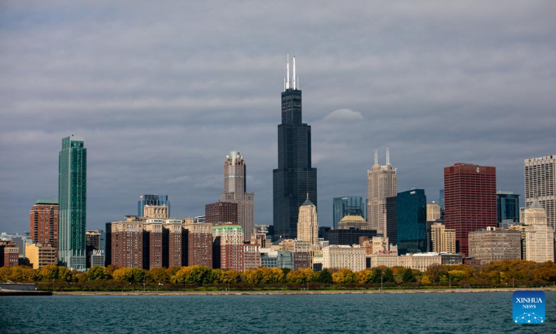 Fall colors blanket the ground of the skyline of Chicago with Lake Michigan in the foreground in downtown Chicago, the United States, Oct. 16, 2022. (Photo by Vincent D. Johnson/Xinhua)