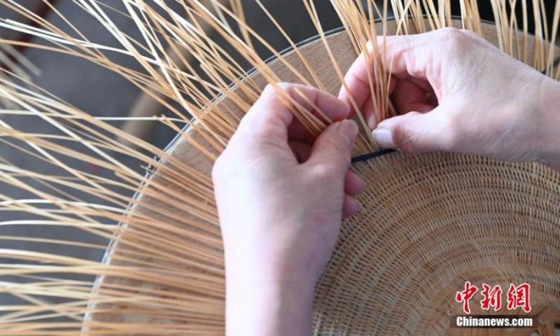 Tan weaves a bamboo hat in Huangjiang Maonan autonomous county, south China's Guangxi Zhuang autonomous region, Oct. 15, 2022. (Photo: China News Service/Wang Yizhao)