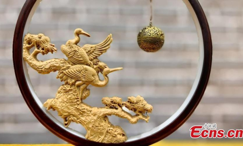 A wood carving artifact is displayed at an exhibition hall in Heze, east China's Shandong Province. Photo: China News Service