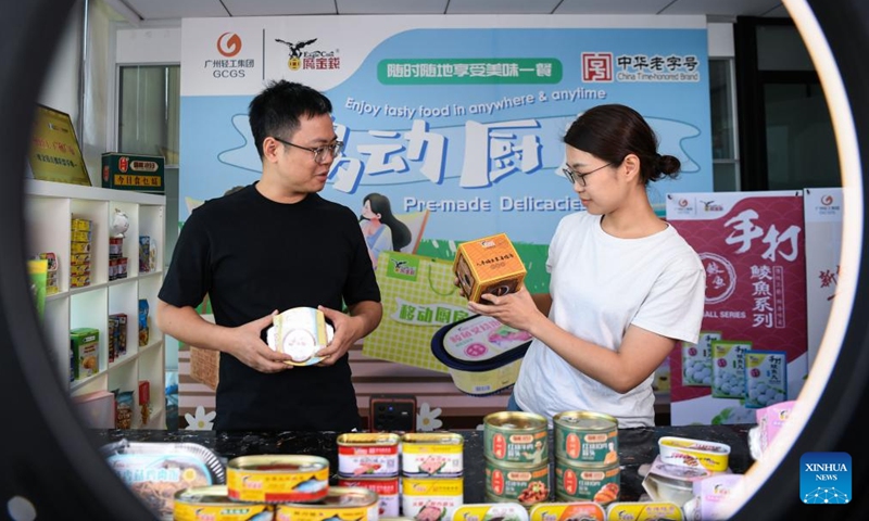 Staff members prepare a live show to be staged for the 132nd session of the China Import and Export Fair, also known as the Canton Fair, at Guangzhou Eagle-Coin Food Group Co., Ltd. in Guangzhou, south China's Guangdong Province, Oct. 14, 2022.Photo:Xinhua