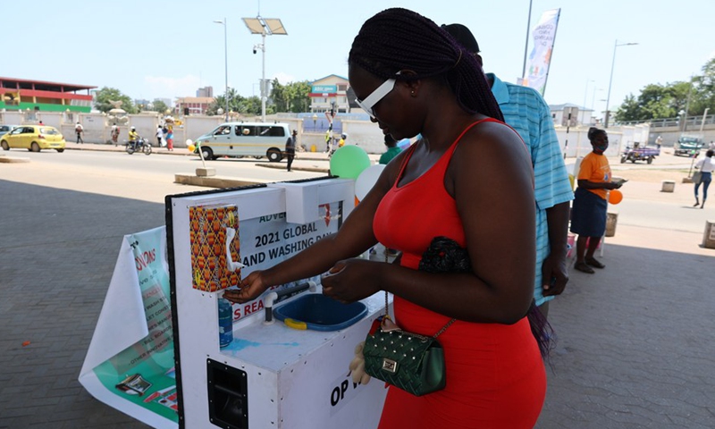 A woman uses a handwashing facility to wash her hands in Accra, Ghana, on Oct. 15, 2021.Photo:Xinhua