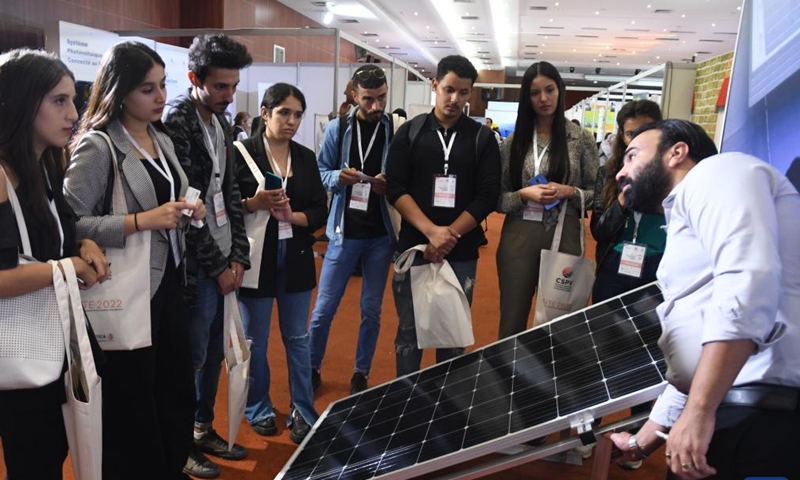 A technician (1st R) introduces a solar panel to visitors at the first International Fair of Energy Transition in Tunis, Tunisia, on Oct. 19, 2022.Photo:Xinhua