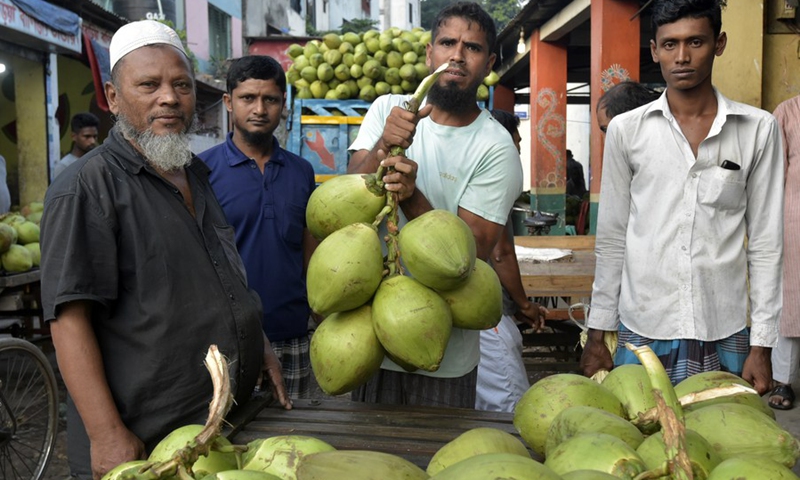 Vendors are selling tender coconuts at a roadside shop in Dhaka, Bangladesh on Oct. 20, 2022.(Photo: Xinhua)