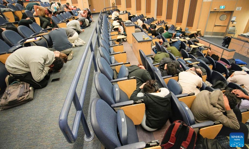 Students do a Drop, Cover and Hold On earthquake drill at University of British Columbia in Vancouver, British Columbia, Canada, on Oct. 20, 2022.(Photo: Xinhua)