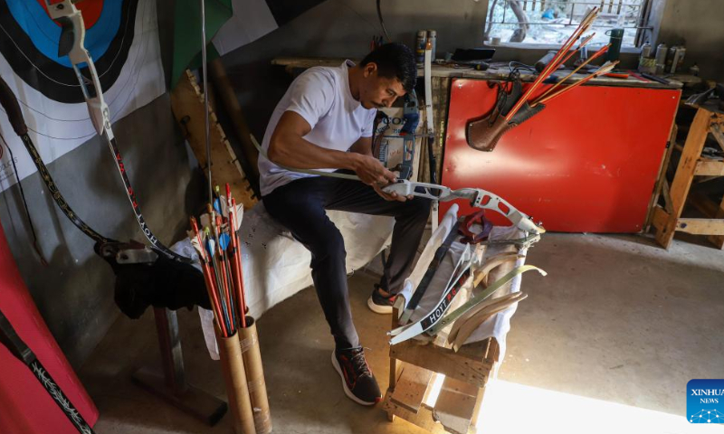 Palestinian Ahmed al-Zahhar makes archery bows and arrows inside his house in Gaza City, Oct. 17, 2022. Armed with the bows that they have handmade themselves, Ahmed al-Zahhar and Wasim Naief, two Gaza-based young Palestinians, aspire to enter the archery competition at the 2024 Olympic Games. Photo: Xinhua