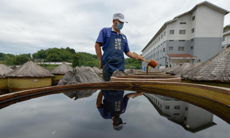 A worker checks the maturity of vinegar in process at a vinegar factory in Chishui, southwest China's Guizhou Province, Oct. 28, 2022. Chishui is celebrated for its sun vinegar, which has maintained a traditional making process. The production techniques of the Chishui vinegar, featuring the sunning process, was listed as a provincial intangible cultural heritage of Guizhou in 2009, and a national one in 2021. The vinegar is noted for its unique flavor also because of its time-tested recipe that include some herbal medicines.