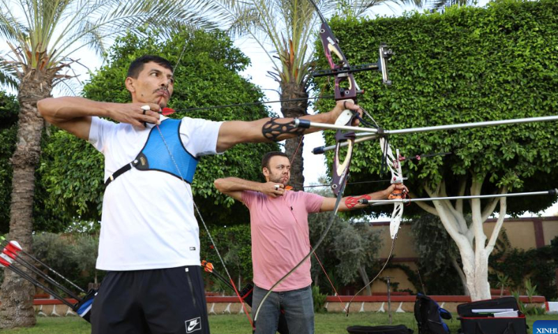 Palestinian Ahmed al-Zahhar (L) and Wasim Naief, practice archery in Gaza City, Oct. 17, 2022. Armed with the bows that they have handmade themselves, Ahmed al-Zahhar and Wasim Naief, two Gaza-based young Palestinians, aspire to enter the archery competition at the 2024 Olympic Games. Photo: Xinhua