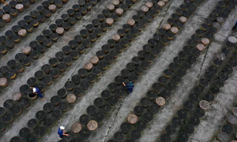 This aerial photo taken on Oct. 28, 2022 shows workers operating at the sunning field of a vinegar factory in Chishui, southwest China's Guizhou Province. Chishui is celebrated for its sun vinegar, which has maintained a traditional making process. The production techniques of the Chishui vinegar, featuring the sunning process, was listed as a provincial intangible cultural heritage of Guizhou in 2009, and a national one in 2021. The vinegar is noted for its unique flavor also because of its time-tested recipe that include some herbal medicines.