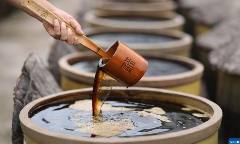 A worker displays mature vinegar at a vinegar factory in Chishui, southwest China's Guizhou Province, Oct. 28, 2022. Photo: Xinhua