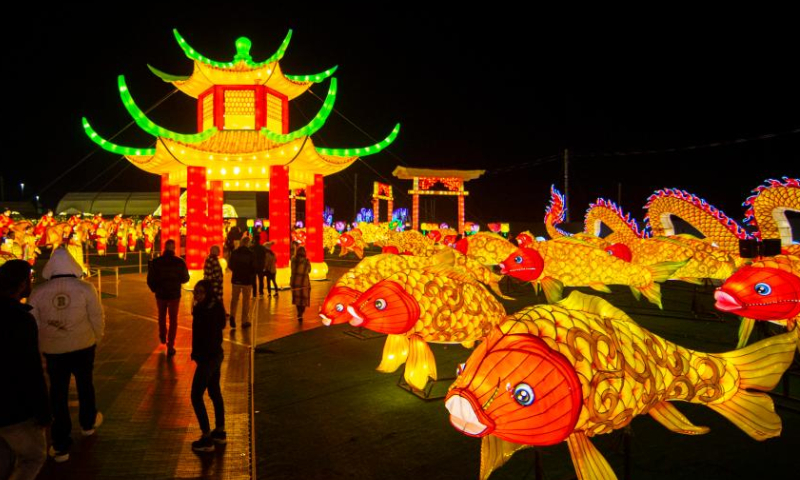 People visit the Illumi: A Dazzling World of Lights show in Mississauga, Ontario, Canada, on Oct. 29, 2022. The light show will last until Jan. 8, 2023. (Photo by Zou Zheng/Xinhua)