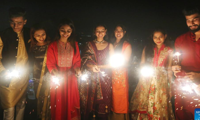 People burn firecrackers on the eve of Diwali, or the Festival of Lights, in Bhopal, capital of India's Madhya Pradesh state, Oct. 23, 2022. Photo: Xinhua