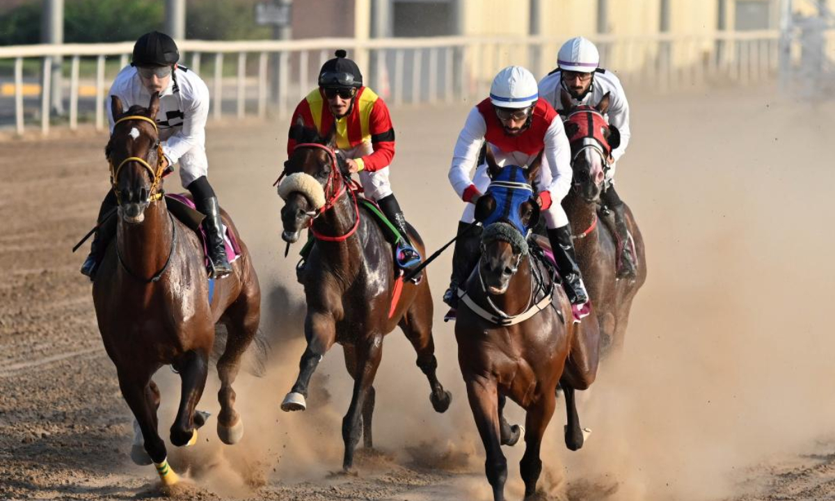 Riders participate in horse racing in Mubarak Al-Kabeer Governorate, Kuwait, Oct 24, 2022. The horse racing season of Kuwait kicked off on Monday at Kuwaiti Hunting and Equestrian Club in Mubarak Al-Kabeer Governorate, with 35 horses participating in 4 races on the first day. Photo:Xinhua