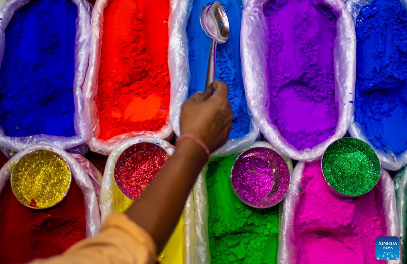 A shopkeeper arranges pigments used for the Tihar festival, or festival of lights, in Kathmandu, Nepal, Oct. 23, 2022. (Photo by Sulav Shrestha/Xinhua)