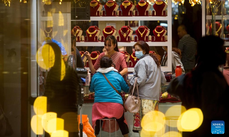 People shop at a gold store for the Tihar festival, or festival of lights, in Kathmandu, Nepal, Oct. 23, 2022. (Photo by Sulav Shrestha/Xinhua)