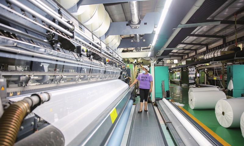 An employee rushes to finish orders at a textile enterprise in Rugao, East China's Jiangsu Province on October 24, 2022. Local businesses are in full swing to deliver products and services in line with an overall economic revival. Photo: cnsphoto