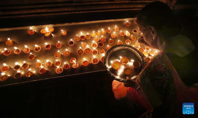 A Hindu devotee lays oil lamps to celebrate Diwali, or the festival of lights, at a Hindu temple in Colombo, Sri Lanka, Oct. 24, 2022.(Photo: Xinhua)