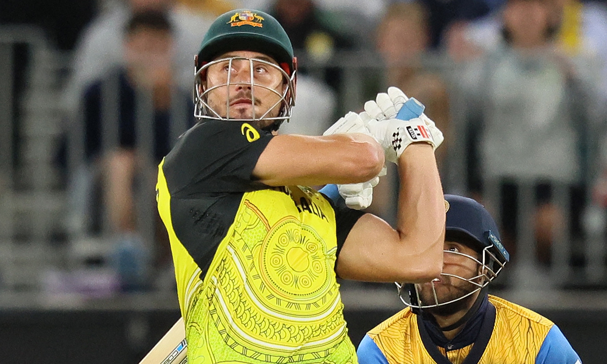 Australia's Marcus Stoinis (front) plays a shot over the boundary line for six runs during the ICC men's Twenty20 World Cup 2022 cricket match in Perth, Australia on October 25, 2022. Photo: AFP