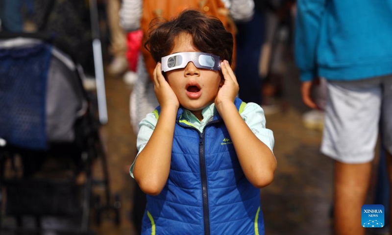 A boy observes a partial solar eclipse through a goggle in Cairo, Egypt, Oct. 25, 2022.(Photo: Xinhua)