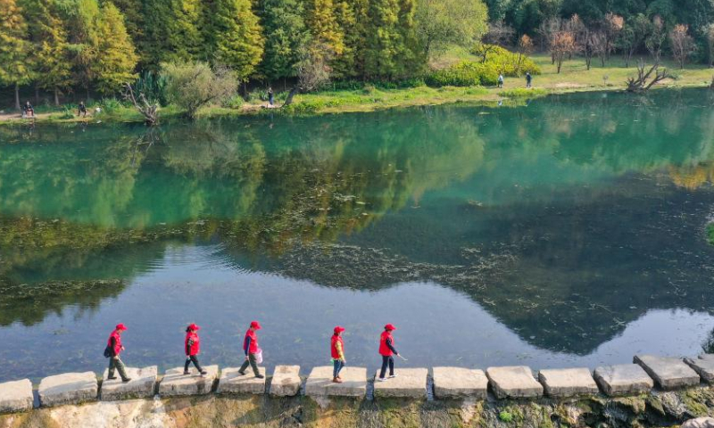 This aerial photo shows Zhou Yuqing (1st R) and other environmental protection volunteers patrolling the Huaxi national city wetland park in Guiyang, capital of southwest China's Guizhou Province on Nov. 4, 2022. Photo: Xinhua