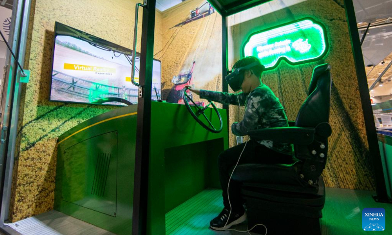 A boy has a VR experience of grain harvest at the Royal Agricultural Winter Fair in Toronto, Canada, on Nov. 4, 2022. As a combined indoor agricultural fair and international equestrian competition, the ten-day annual event kicked off here on Friday to celebrate its 100th anniversary. Photo: Xinhua