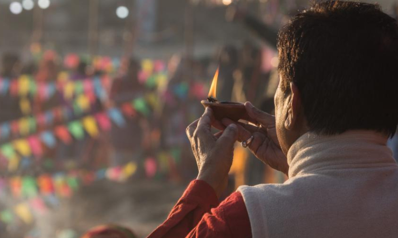 A man worships the rising sun during the Chhath festival on the bank of the Bagmati River in Kathmandu, Nepal, Oct. 31, 2022. The Chhath festival is dedicated to the sun, which is regarded as a token of stability and prosperity, and a Vedic goddess Chhathi Maiya. (Photo by Hari Maharjan/Xinhua)