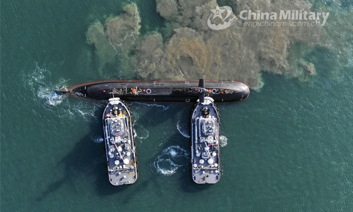 Two towboats attached to a submarine flotilla with the navy under the PLA Northern Theater Command jointly tow a submarine off a dock during a maritime drill on torpedo attack and defense, submarine control, etc. on October 25, 2022. Photo:China Military