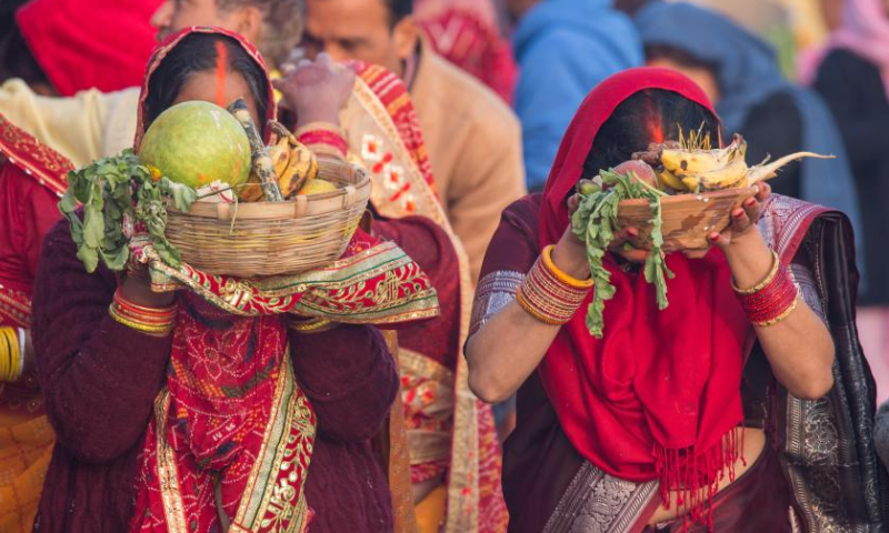 People worship the rising sun during the Chhath festival on the bank of the Bagmati River in Kathmandu, Nepal, Oct. 31, 2022. The Chhath festival is dedicated to the sun, which is regarded as a token of stability and prosperity, and a Vedic goddess Chhathi Maiya. (Photo by Hari Maharjan/Xinhua)