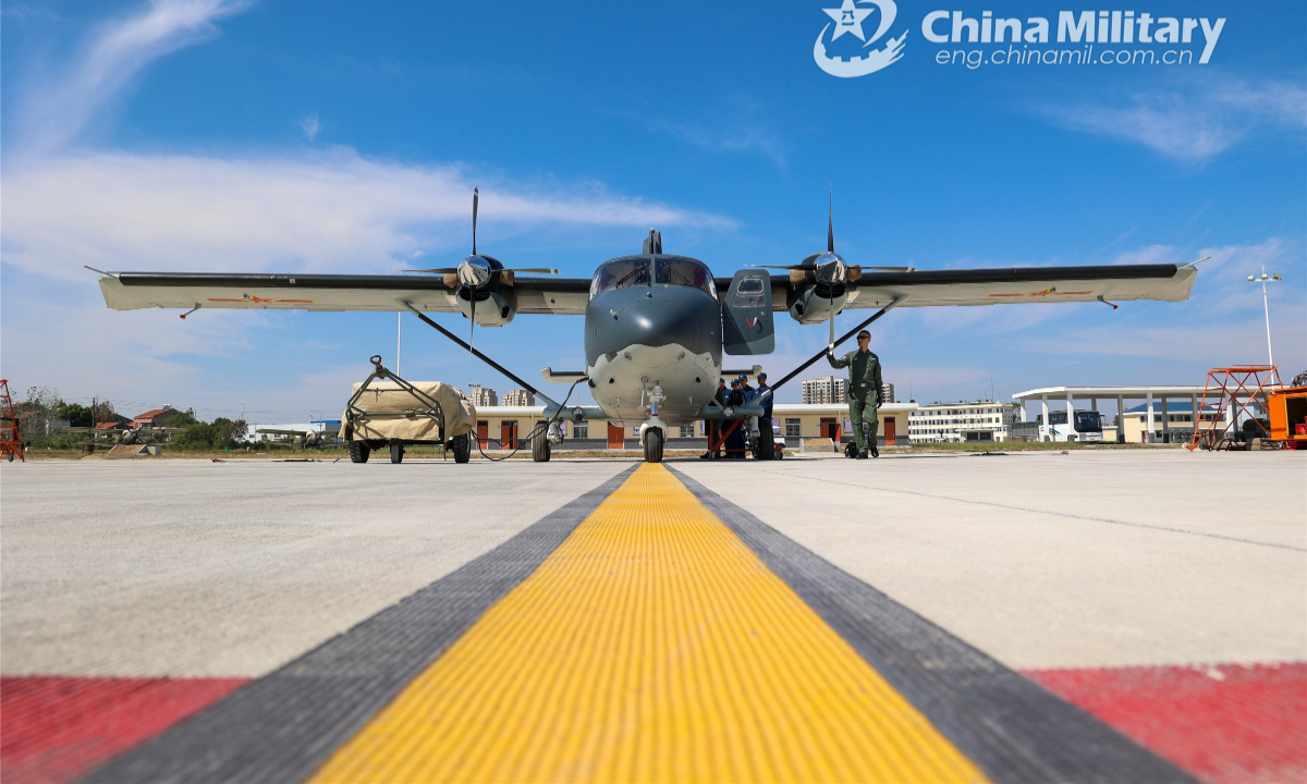 Ground crew members assigned to an airborne brigade of the PLA air force conduct regular inspection and maintenance on a Y-12 transport aircraft during a multi-subject flight training exercise on Oct 11, 2022. Photo:Xinhua