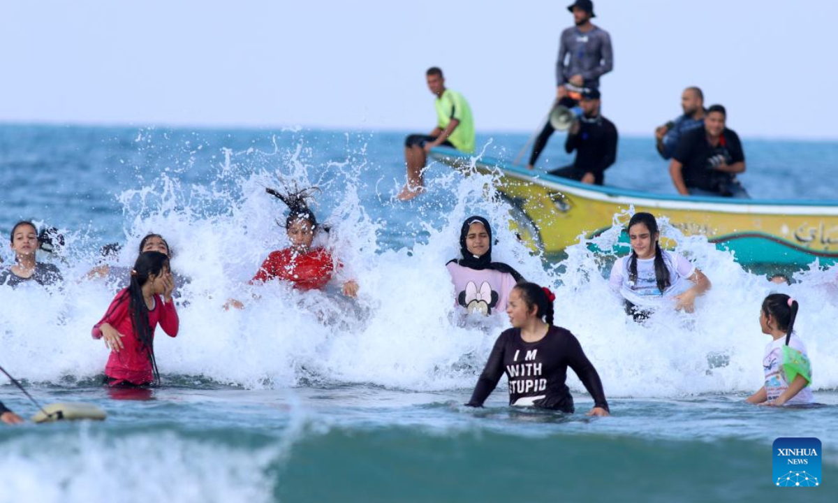 Palestinian children take part in a swimming carnival in the Mediterranean Sea off Beit Lahia, northern Gaza Strip, on Nov 3, 2022. Photo:Xinhua