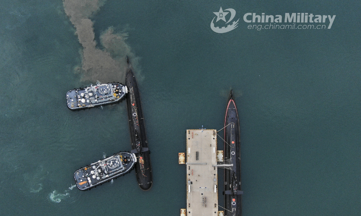 Two towboats attached to a submarine flotilla with the navy under the PLA Northern Theater Command jointly tow a submarine off a dock during a maritime drill on torpedo attack and defense, submarine control, etc. on October 25, 2022. Photo:China Military