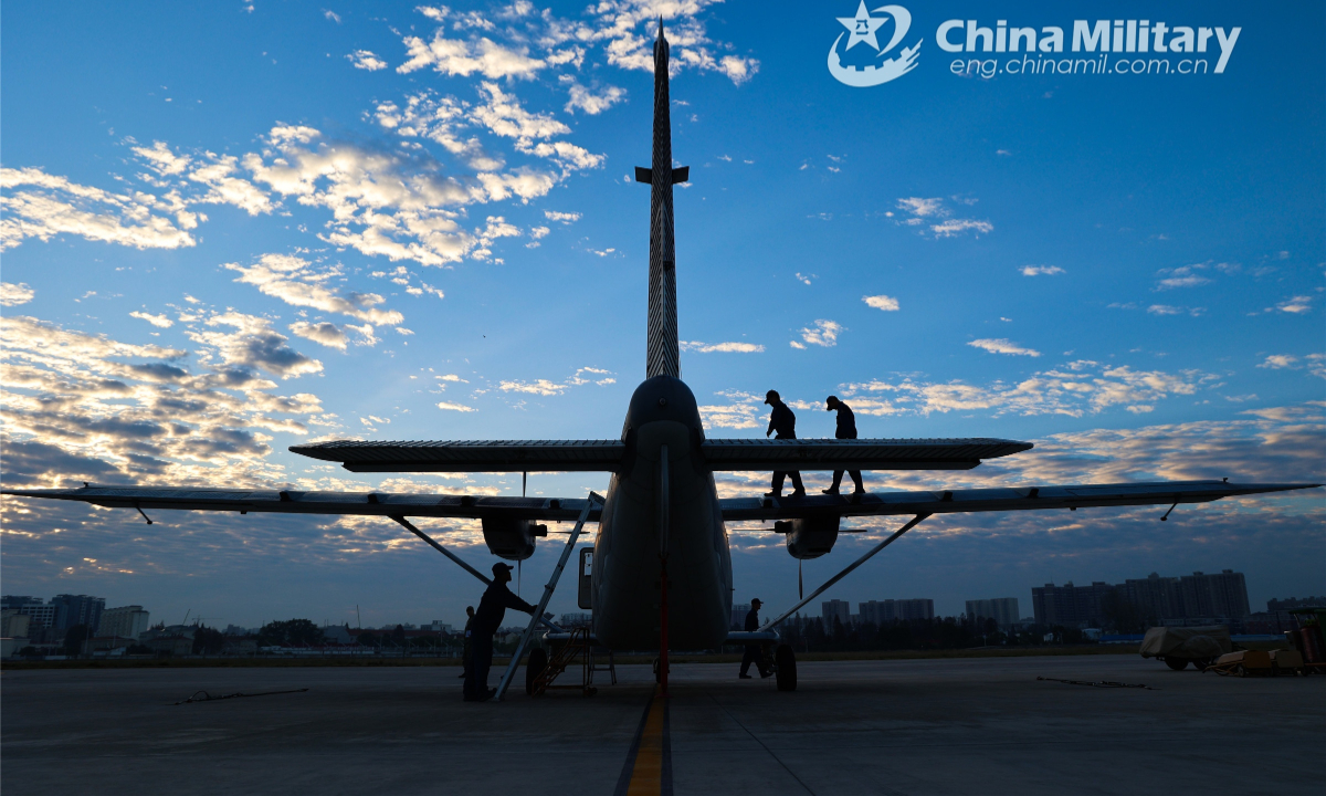 Ground crew members assigned to an airborne brigade of the PLA air force conduct regular inspection and maintenance on a Y-12 transport aircraft during a multi-subject flight training exercise on Oct 11, 2022. Photo:Xinhua