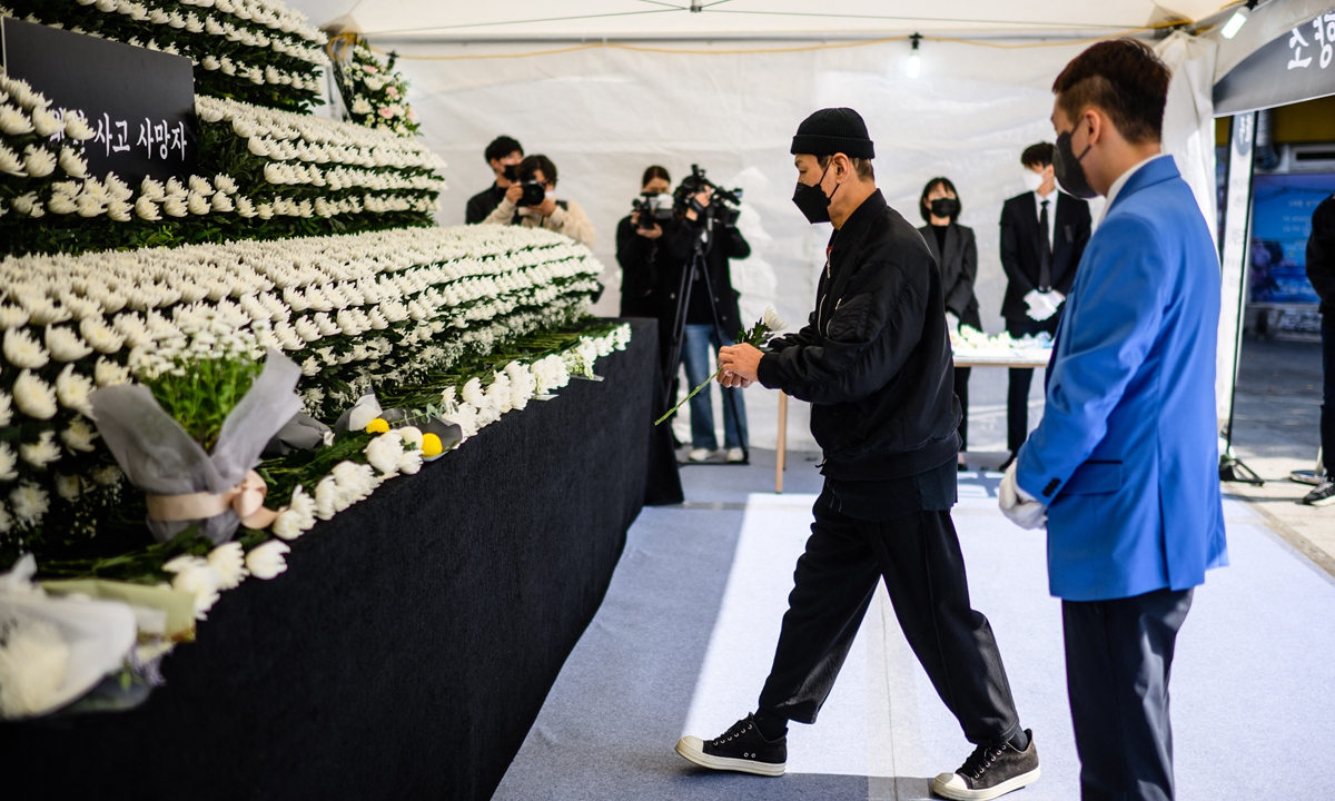 A man places a flower at a joint memorial altar for victims of the deadly Halloween crowd surge, in Naksopyeong, near the district of Itaewon in Seoul, South Korea on October 31, 2022. Photo: AFP