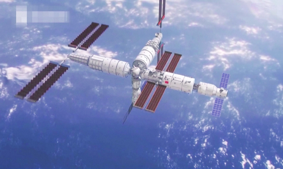 Mengtian, Tiangong's second lab module, docks with the front port of Tianhe, the space station's core module, at 4:27 am Tuesday (Beijing Time) after it entered the planned orbit. The Mengtian module, together with Tianhe core module and Wentian lab module, will form the space station's basic configuration in T shape (See the story on Page 4). Photo: VCG