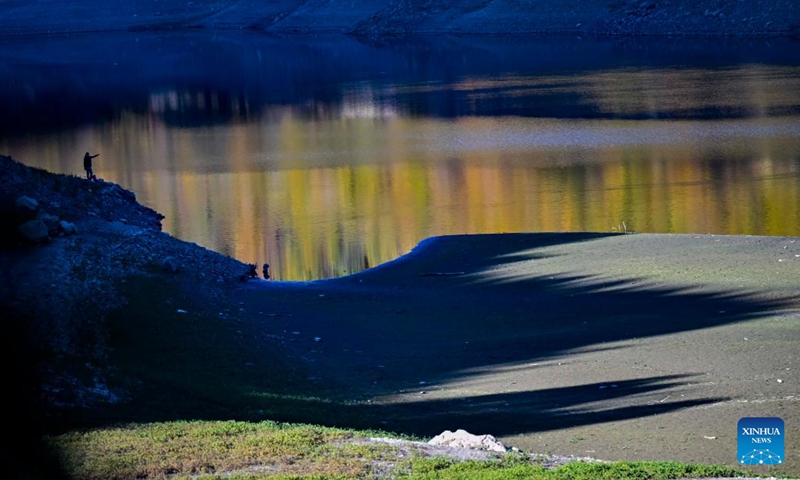 A person fishes at Debar Lake in North Macedonia, Oct. 30, 2022.(Photo: Xinhua)