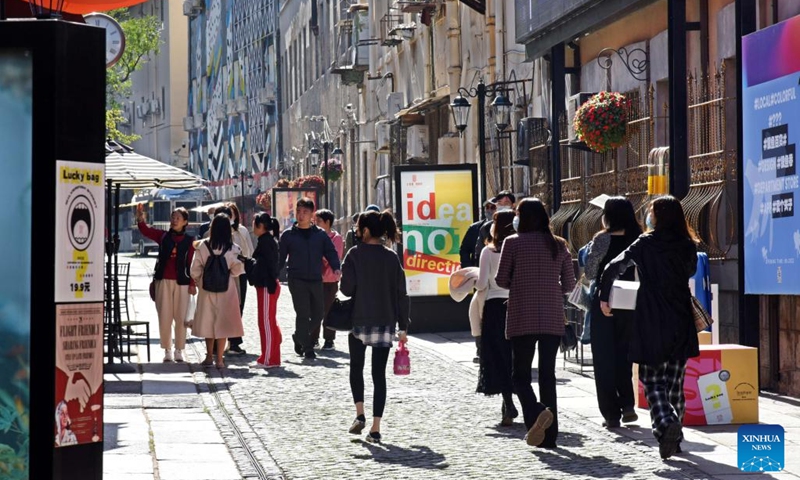 Visitors are seen at Silverfish ST. in Qingdao, east China's Shandong Province, Nov. 1, 2022. In recent years, the old city area of Qingdao has started protective renovation of its historical and cultural communities, during which ancient buildings have been maintained and new industries and trades have brought vitality to the city.(Photo: Xinhua)