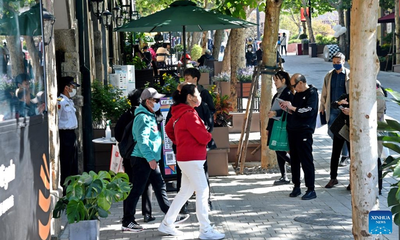 People visit at the Dabaodao blocks in Qingdao, east China's Shandong Province, Oct. 19, 2022. In recent years, the old city area of Qingdao has started protective renovation of its historical and cultural communities, during which ancient buildings have been maintained and new industries and trades have brought vitality to the city.(Photo: Xinhua)