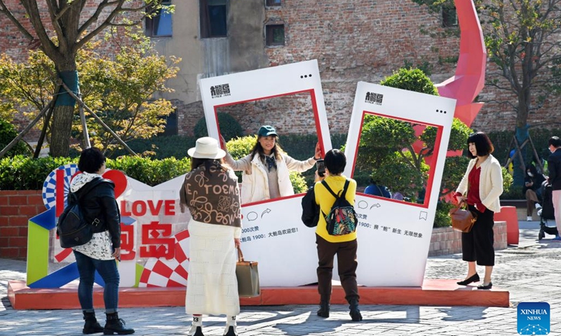 People visit at the Dabaodao blocks in Qingdao, east China's Shandong Province, Oct. 19, 2022. In recent years, the old city area of Qingdao has started protective renovation of its historical and cultural communities, during which ancient buildings have been maintained and new industries and trades have brought vitality to the city.(Photo: Xinhua)