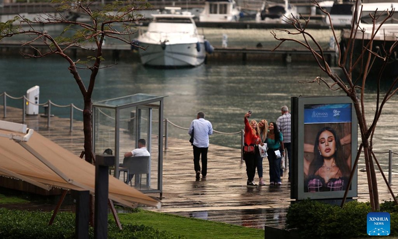 Pedestrians take a selfie by the water in Beirut, Lebanon on Nov. 2, 2022.(Photo: Xinhua)