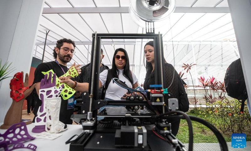 Visitors watch a 3D printing equipment at Rio Innovation Week in Rio de Janeiro, Brazil, on Nov. 8, 2022. The four-day Rio Innovation Week opened in Rio de Janeiro on Tuesday. (Xinhua/Wang Tiancong)