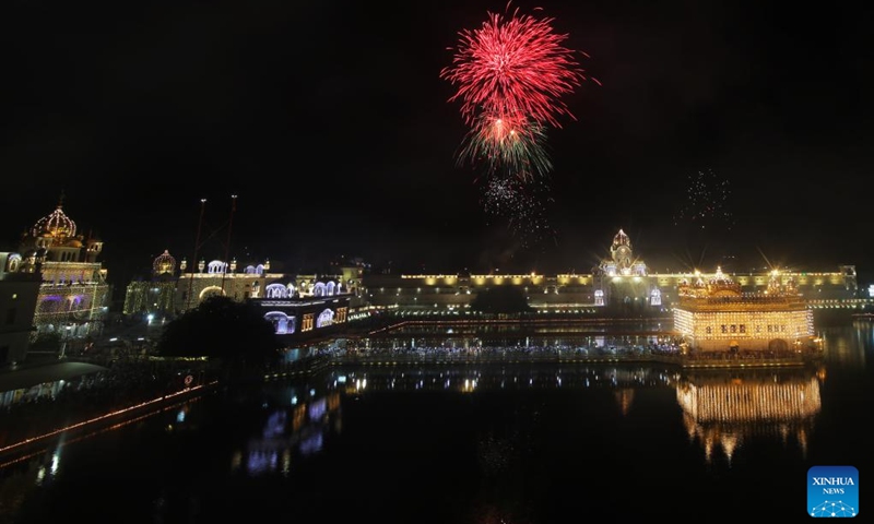 Fireworks are seen in the sky over the illuminated Golden Temple on the occasion of the birth anniversary of Guru Nanak Dev in Amritsar district of India's northern Punjab state, Nov. 8, 2022. (Str/Xinhua)