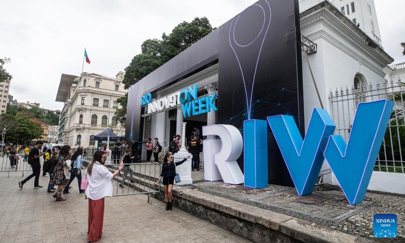 Visitors take pictures at the entrance of Rio Innovation Week in Rio de Janeiro, Brazil, on Nov. 8, 2022. The four-day Rio Innovation Week opened in Rio de Janeiro on Tuesday. (Xinhua/Wang Tiancong)