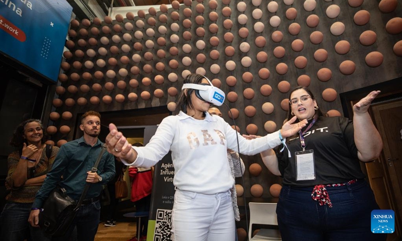 A visitor experiences a VR headset at Rio Innovation Week in Rio de Janeiro, Brazil, on Nov. 8, 2022. The four-day Rio Innovation Week opened in Rio de Janeiro on Tuesday. (Xinhua/Wang Tiancong)