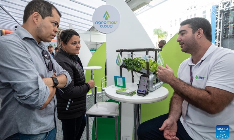 A staff member explains a plant growth monitoring system to visitors at Rio Innovation Week in Rio de Janeiro, Brazil, on Nov. 8, 2022. The four-day Rio Innovation Week opened in Rio de Janeiro on Tuesday. (Xinhua/Wang Tiancong)